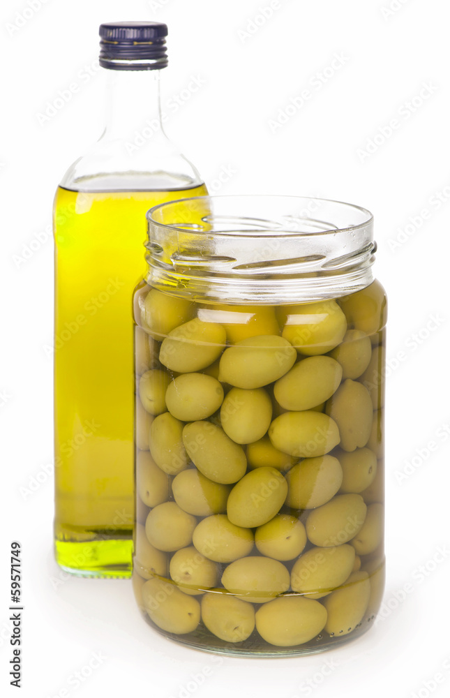 Green olives preserved in bank and a bottle of olive oil Green olives preserved in bank and a bottle of olive oil