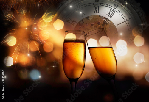 champagne glasses and clock at midnight