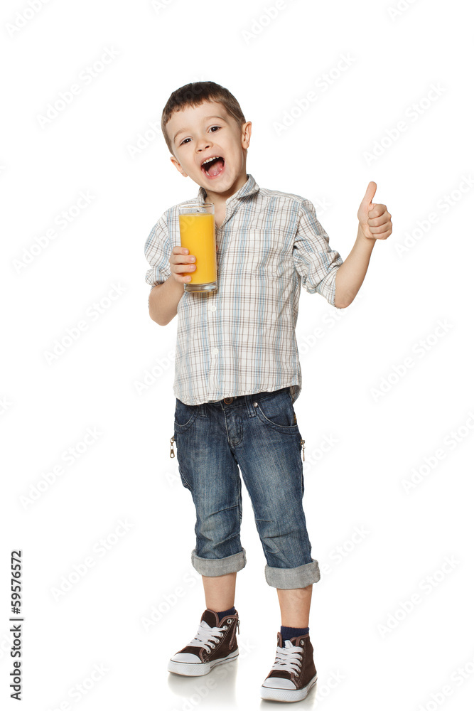 Little boy with a glass of juice lifts finger upwards. Little boy with a glass of juice lifts finger upwards.