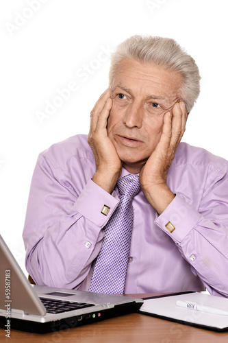 Elderly businessman with laptop