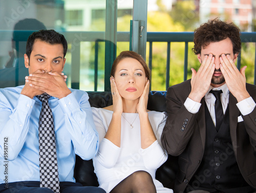 Businesspeople imitating see, hear, speak no evil concept photo