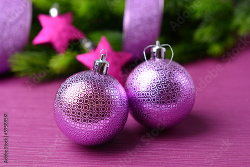 Christmas balls on fir tree, on color background