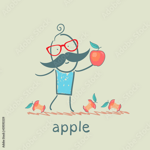 man holding an apple lying around and eats apples