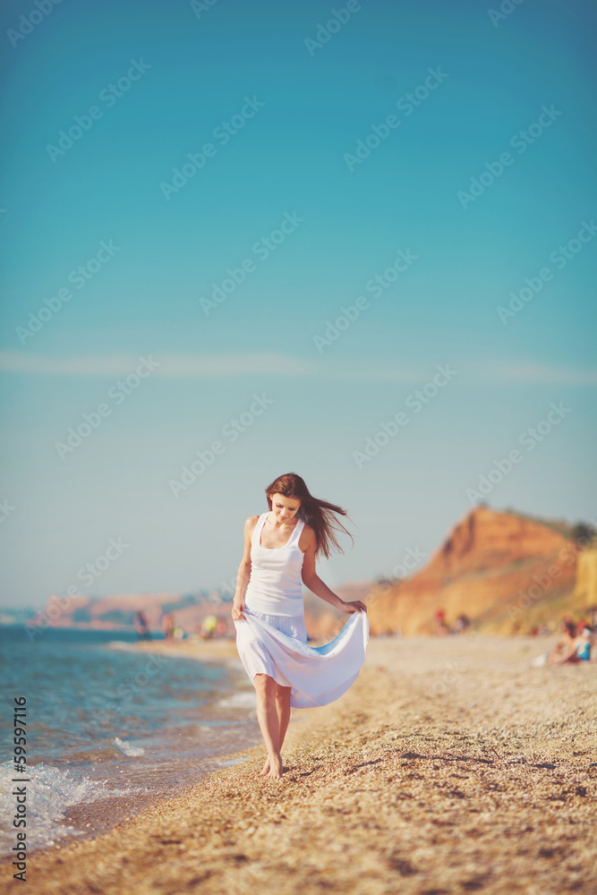 portrait of a beautiful young woman on the beach in the sand portrait of a beautiful young woman on the beach in the sand