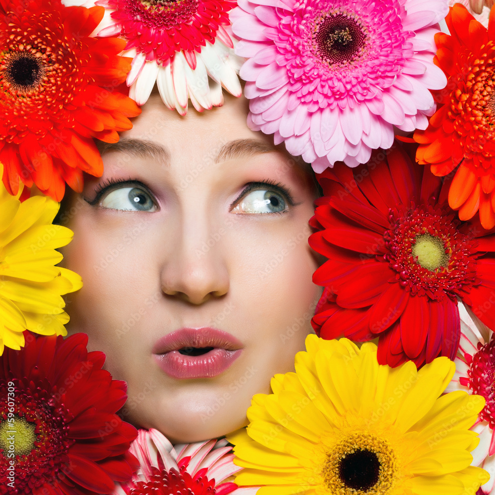 Young girl with flowers around her face. Gerbera daisy flowers Young girl with flowers around her face. Gerbera daisy flowers