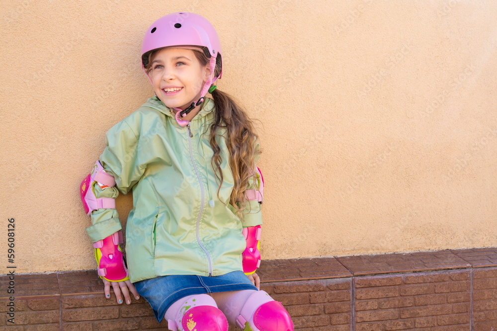 Girl with roller skates in helmet and protection Girl with roller skates in helmet and protection