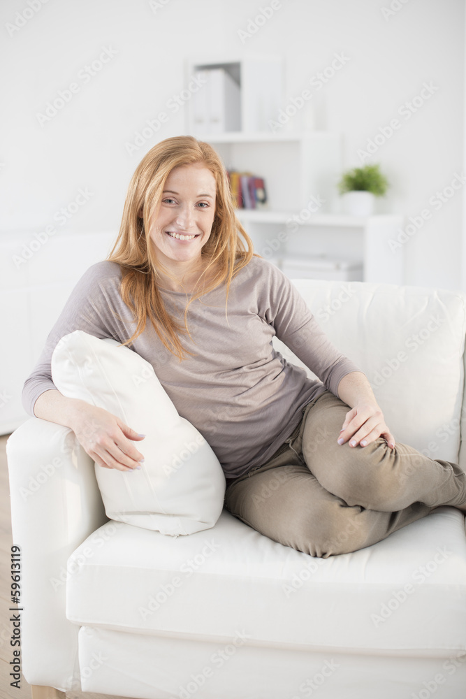 beautiful smiling woman sitting on couch beautiful smiling woman sitting on couch
