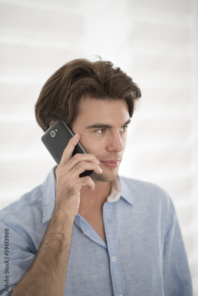 closeup of an attractive man at phone closeup of an attractive man at phone