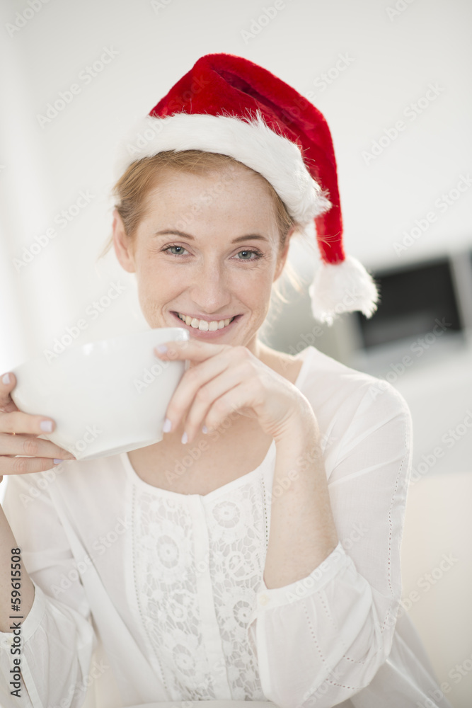 closeup young woman at breakfast with Santa Claus hat