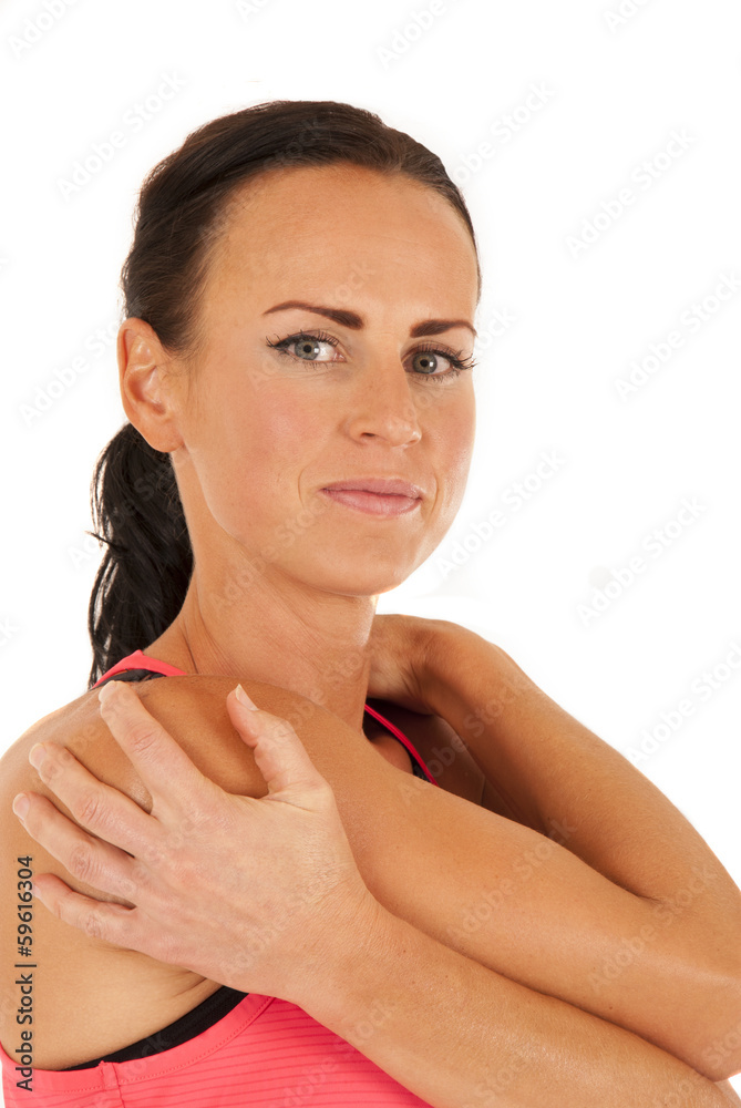 Attractive female model stretching arms before workout Attractive female model stretching arms before workout