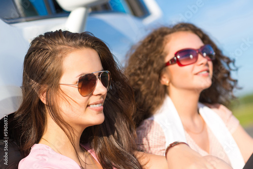 Two attractive young women wearing sunglasses © adam121