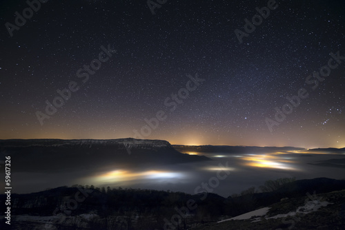 Stars in a foggy night over the valley © inigocia