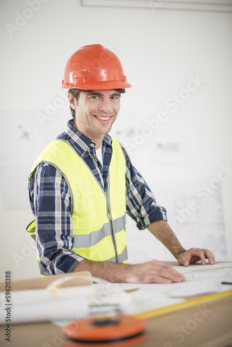 foreman in his office reviewing building plans