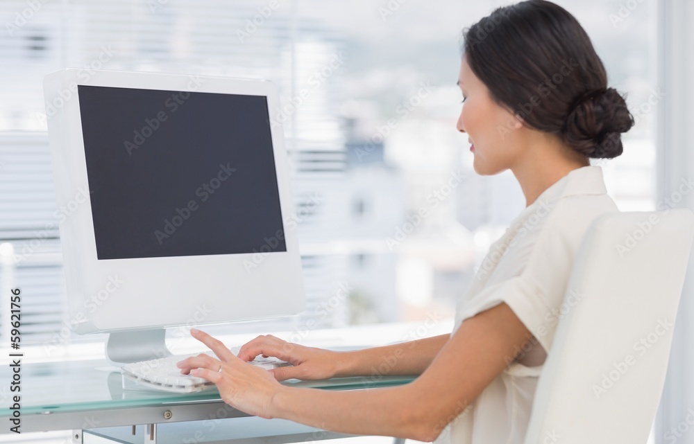 Young businesswoman using computer in office Young businesswoman using computer in office