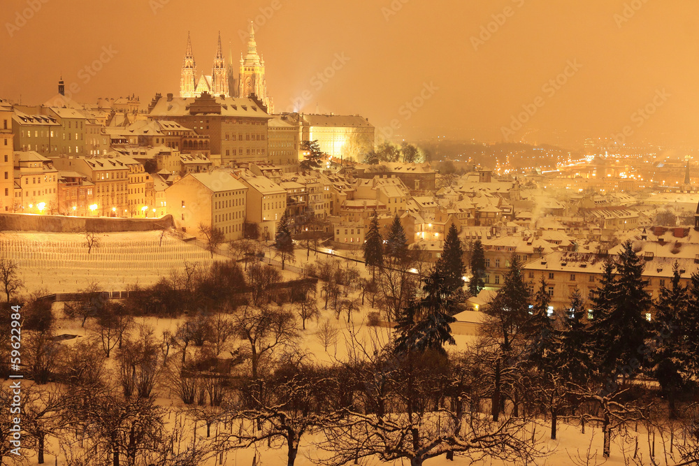 Naklejka premium Night snowy Prague City with gothic Castle, Czech republic