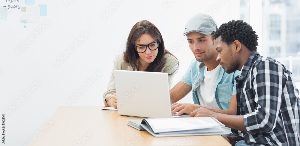 Artists working at desk in creative office