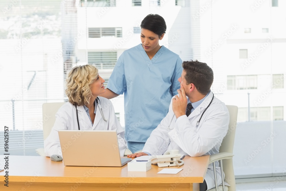 Three concentrated doctors in discussion Three concentrated doctors in discussion