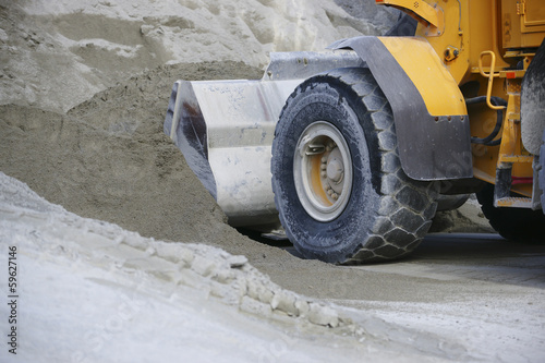 Wheel loader Excavator unloading sand during earth moving works