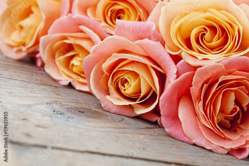 Bouquet of beautiful roses on wooden background