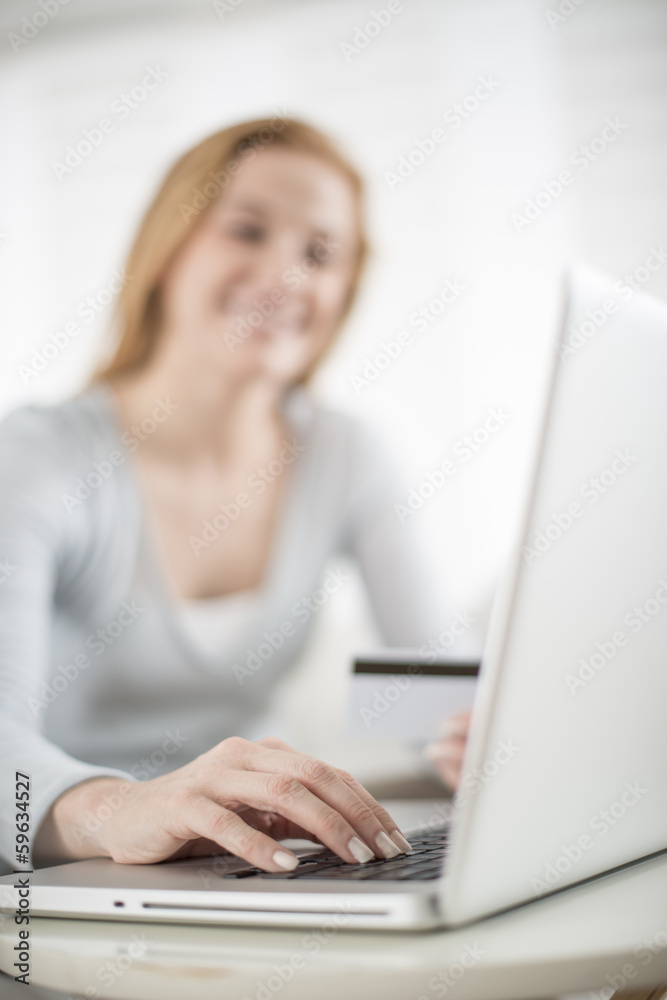 a woman paying with credit card on e-commerce a woman paying with credit card on e-commerce