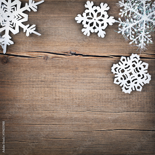 Christmas snowflakes on wooden background