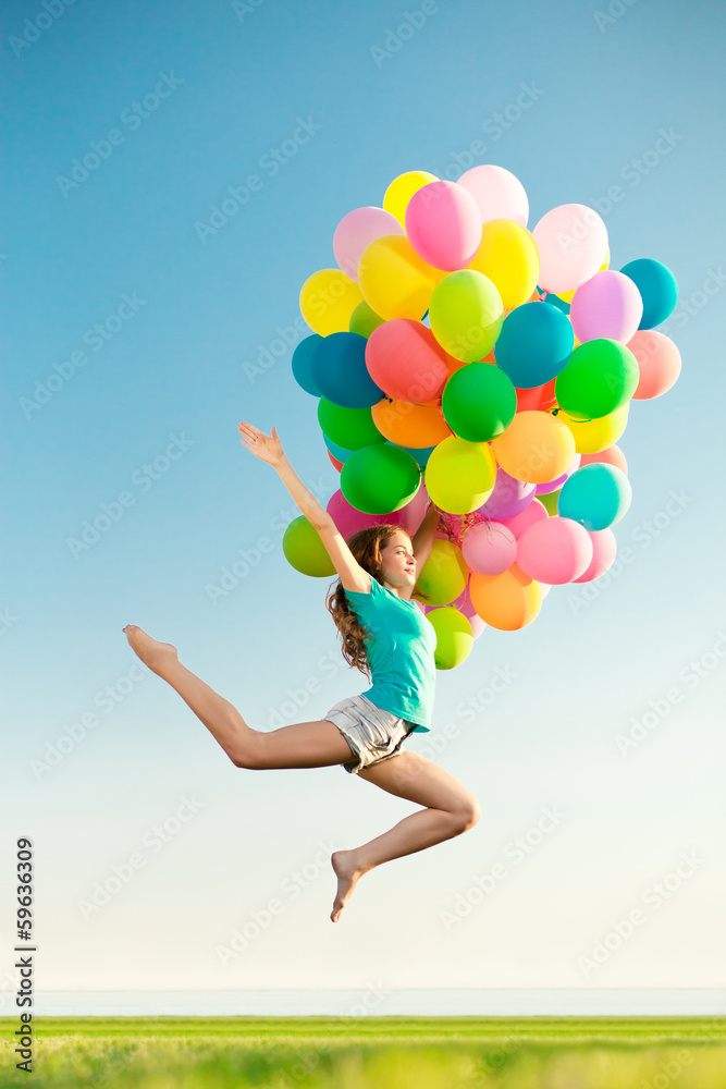 Happy birthday woman against the sky with rainbow-colored air ba Happy birthday woman against the sky with rainbow-colored air ba