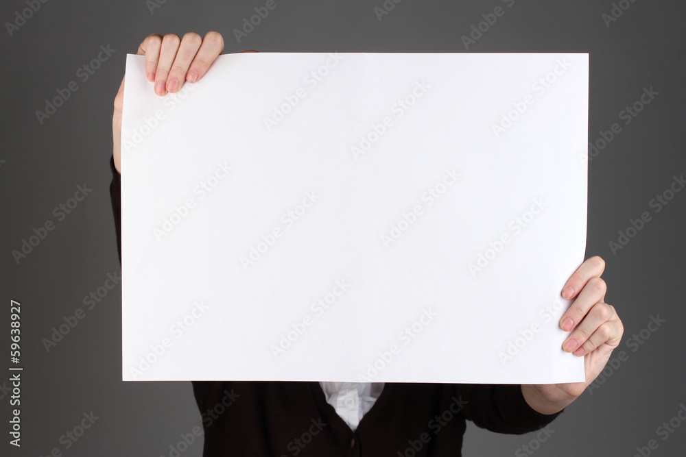 Woman holding blank sign in front her face, on color background Woman holding blank sign in front her face, on color background