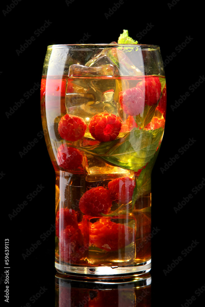 Iced tea with raspberries and mint on black background Iced tea with raspberries and mint on black background