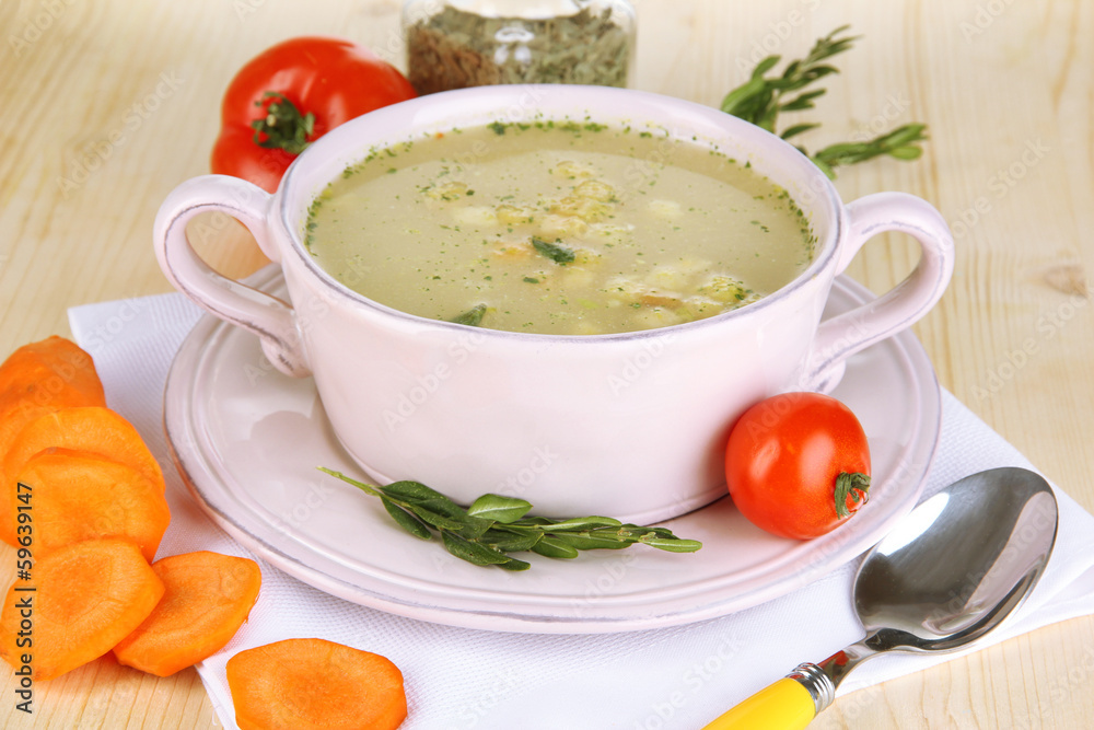 Nourishing soup in pink pan with ingredients Nourishing soup in pink pan with ingredients