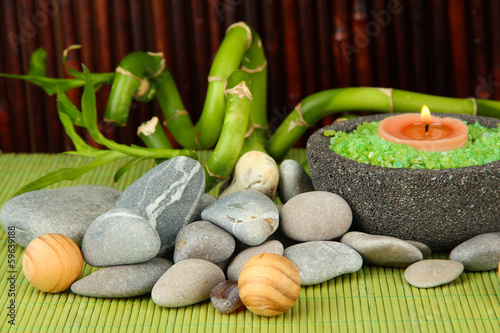 Still life with green bamboo plant and stones,