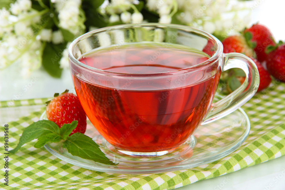 Delicious strawberry tea on table close-up Delicious strawberry tea on table close-up