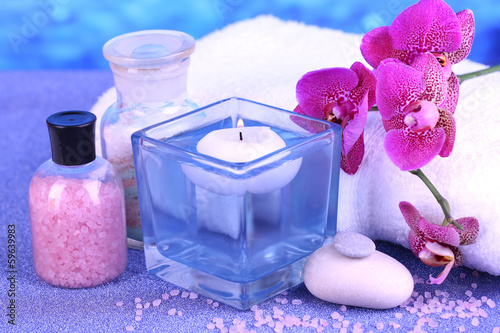 Fototapeta Naklejka Na Ścianę i Meble -  Beautiful spa setting with orchid on blue background