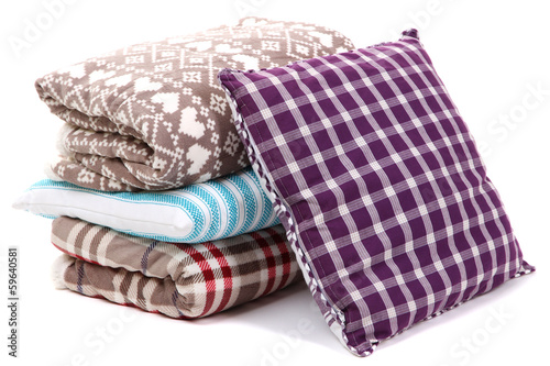 Warm plaids and pillows isolated on white