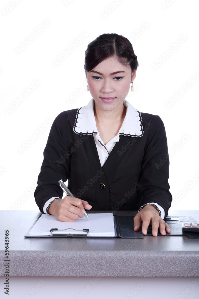 business woman sitting on her desk holding a pen working with do business woman sitting on her desk holding a pen working with do
