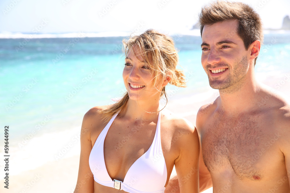 Young couple enjoying paradisiacal beach