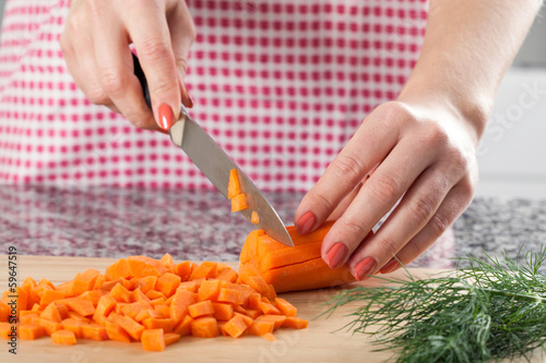 Woman chopping carrot