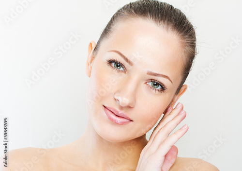 Beautiful face of young adult woman with clean fresh skin