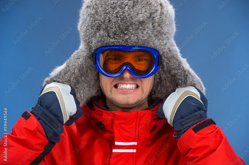 Portrait of male face in winter hat with emotions.
