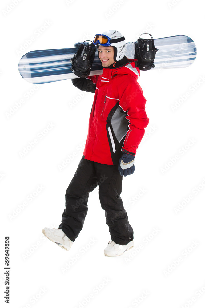 Happy attractive snowboarder walking with snowboard. Happy attractive snowboarder walking with snowboard.