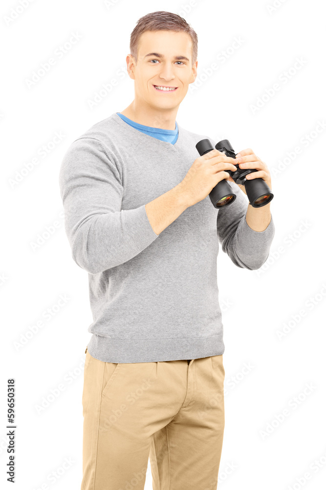 Smiling casual man holding a binocular and looking at camera Smiling casual man holding a binocular and looking at camera