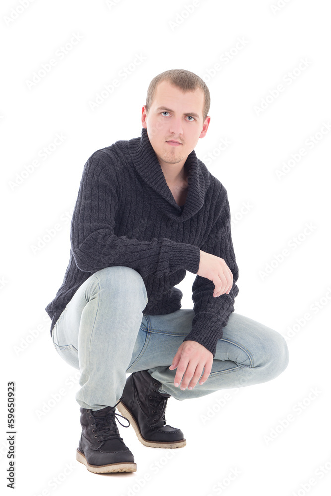 attractive man in winter clothes sitting isolated on white attractive man in winter clothes sitting isolated on white