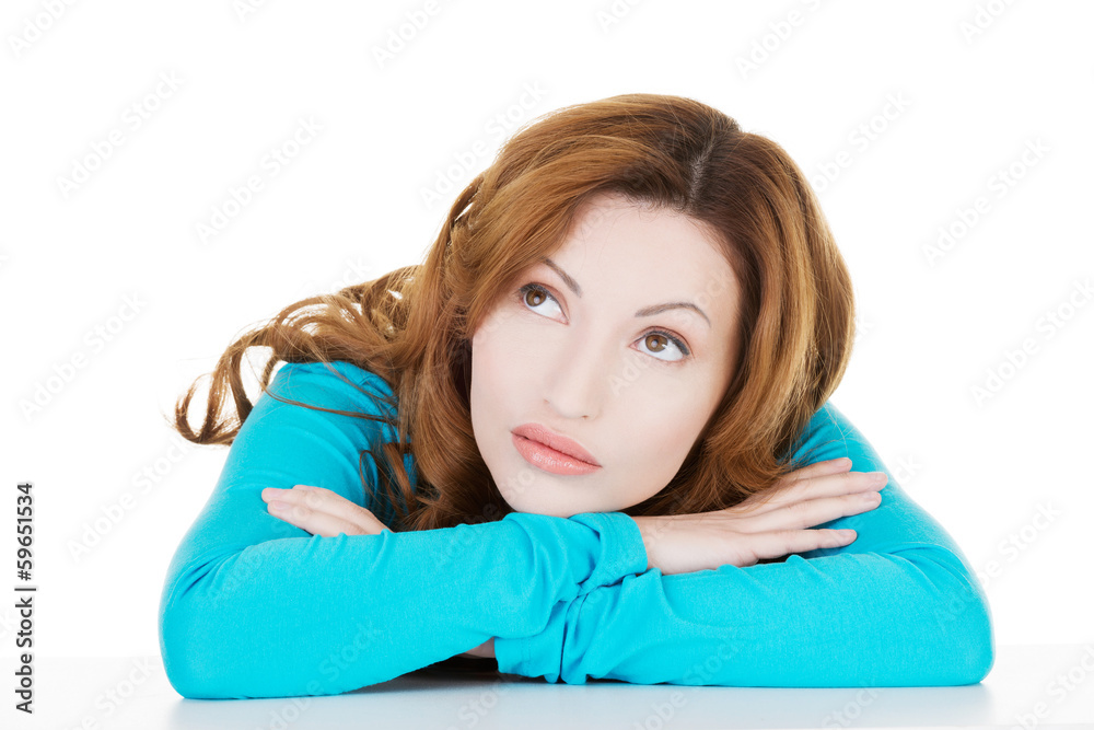 Beautiful causal woman sitting with her head down. Beautiful causal woman sitting with her head down.