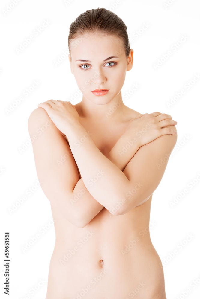 Attractive naked woman with crossed hands on her breasts. Front Stock Photo  | Adobe Stock