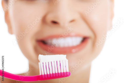 Young beautiful woman with toothbrush and paste.