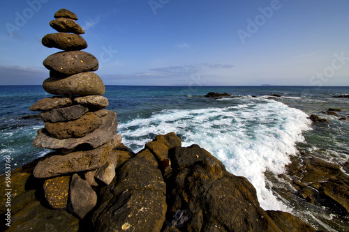 in lanzarote coastline froth rock stone sky cloud beach