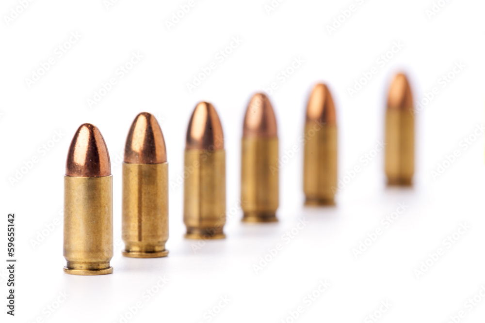 Row of 9mm bullets on white backgronud. Row of 9mm bullets on white backgronud.