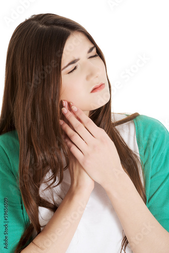 Beautiful young woman having toothache.
