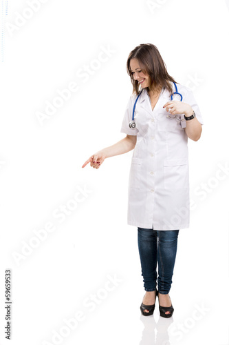 Beautiful young veterinary looking down and pointing, isolated o