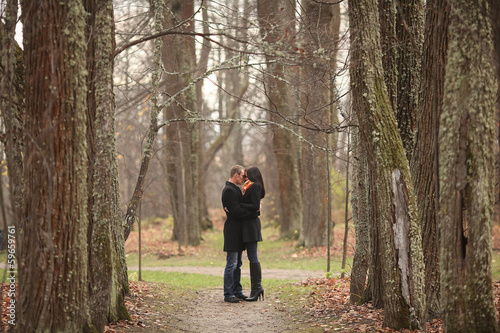 young lovers man and woman in the autumn forest