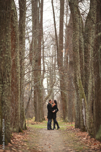 young lovers man and woman in the autumn forest